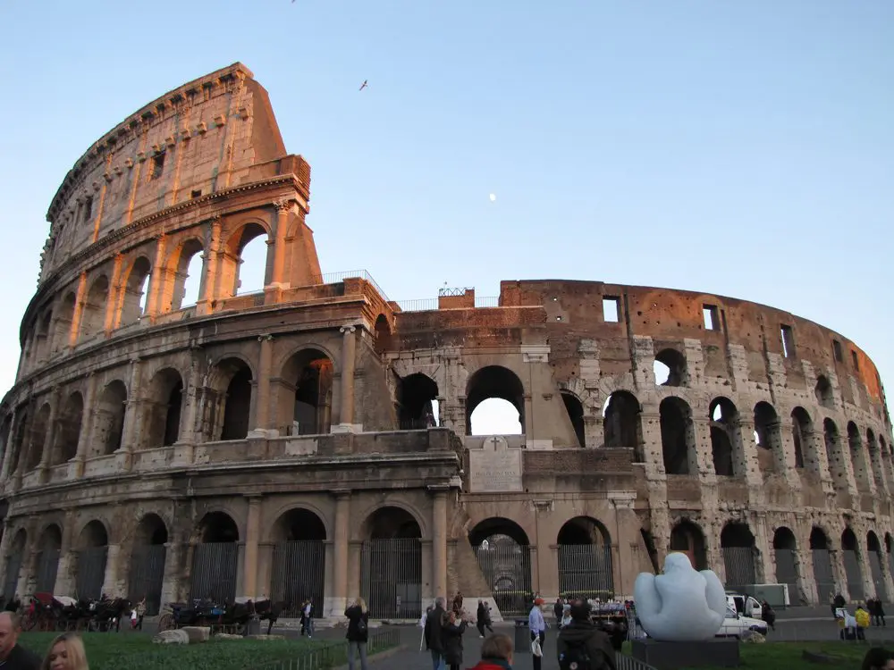 A group of people standing in front of an old building.