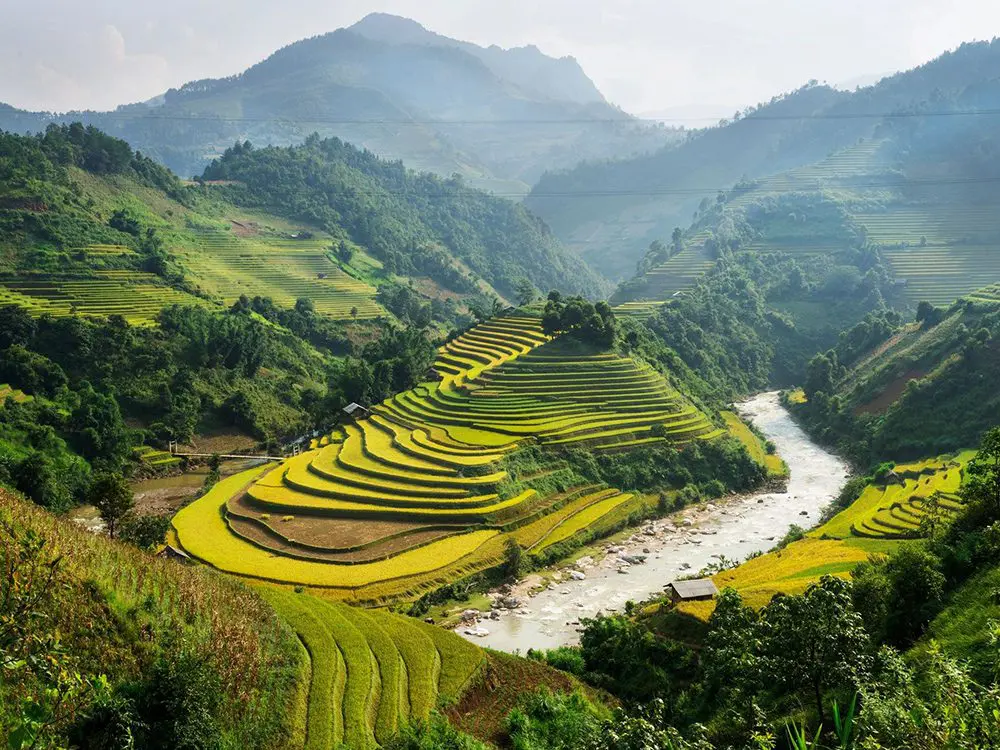 A river running through the middle of a green valley.