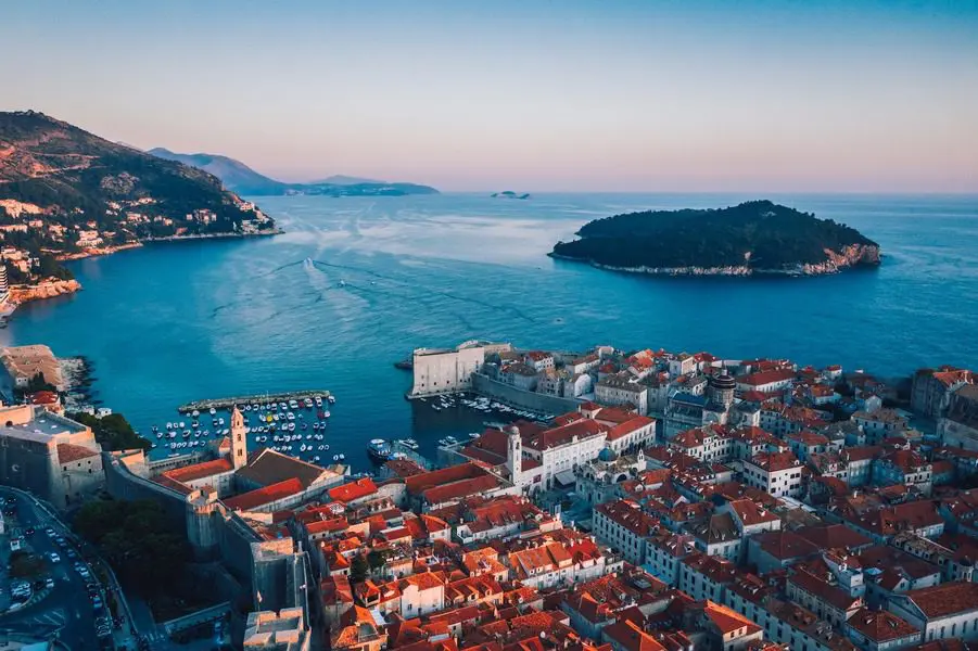 A view of the city from above, with boats in the water.