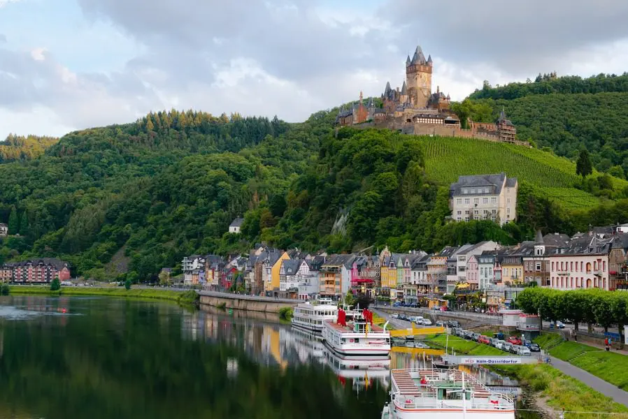 A view of a town with boats docked in the water.